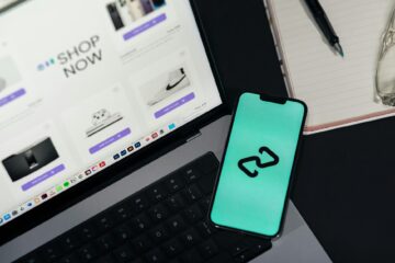 A smartphone and laptop displaying online shopping platforms, suggesting digital retail. (Photo by Julio Lopez on Pexels)