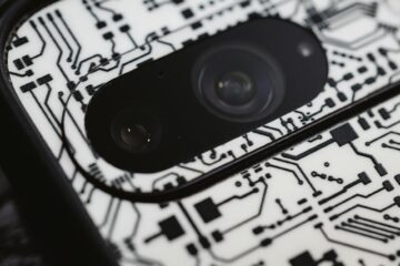 Macro shot of an electronic circuit design around a smartphone camera lens, showing intricate det... (Photo by Sebastian Luna on Pexels)