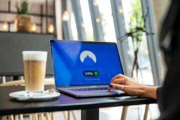A person using a laptop with a VPN connection in a modern cafe setting, showcasing remote work an... (Photo by Stefan Coders on Pexels)