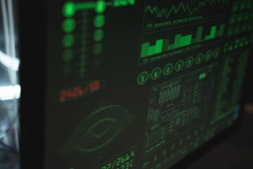 Close-up view of a computer displaying cybersecurity and data protection interfaces in green tones. (Photo by Tima Miroshnichenko on Pexels)